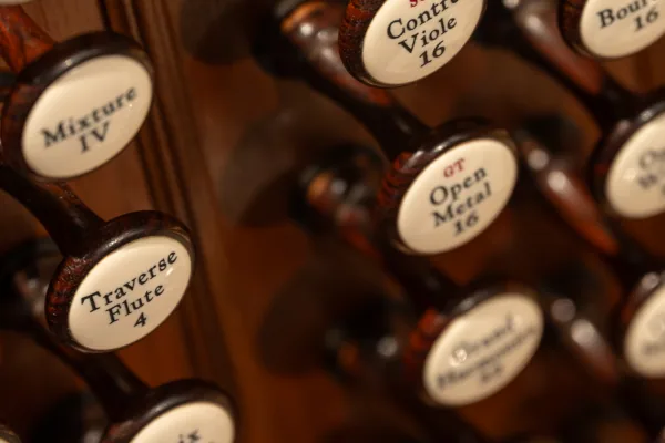 Close-up of the Bicentennial Pipe Organ's stop knobs, labelled Mixture IV, Traverse Flute 4 and Open Metal 16