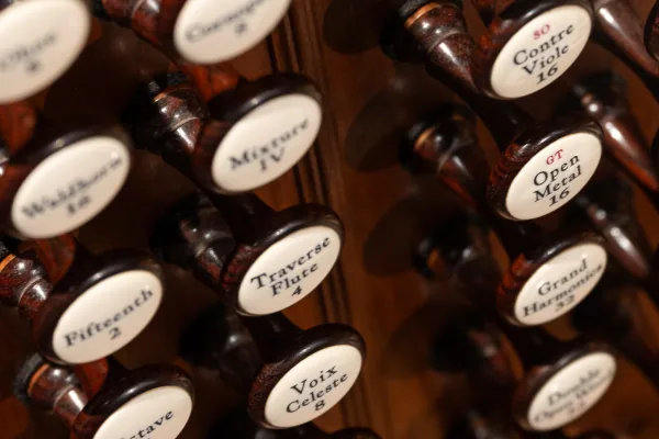 Rows of engraved ivory stop knobs on the Bicentennial Pipe Organ, including Voix Celeste and Grand Harmonique