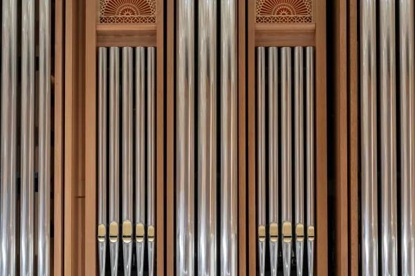 Detail of the Bicentennial Pipe Organ's polished façade pipes with gilded decorative panels above