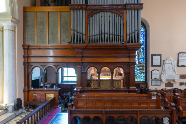 The timber case and pipework of the previous pipe organ in the gallery of St James' Church