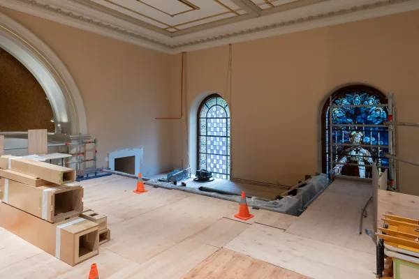 The empty organ gallery of St James' Church during building work, with the floor stripped back